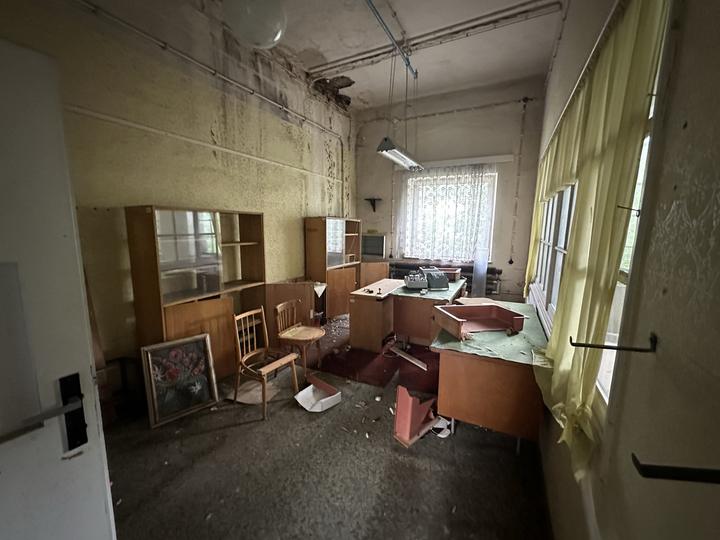 Abandoned site office with its furniture and curtains still in place
