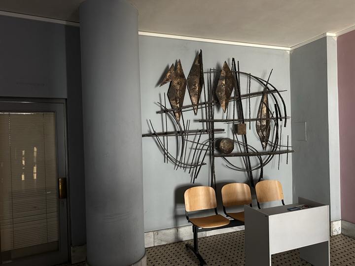 Lobby with seating and a wall sculpture