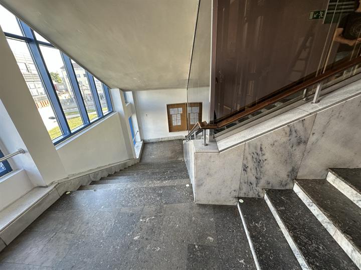 Service stairwell with a window wall and stone treads