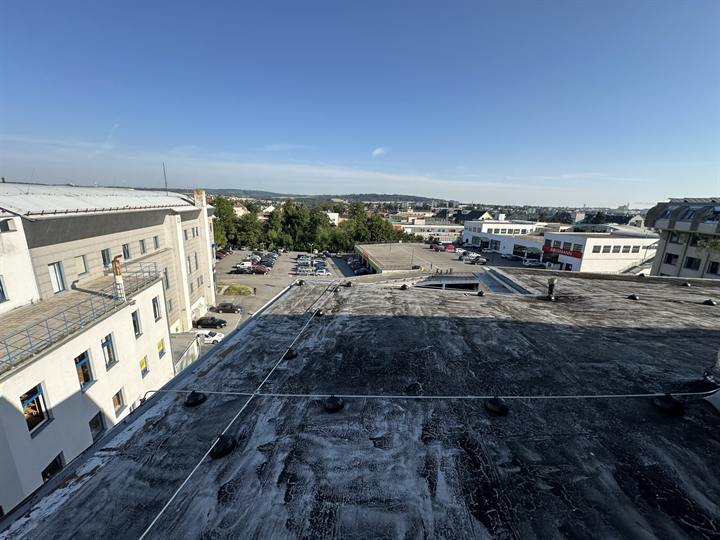 Flat roof above low-rise buildings and a car park