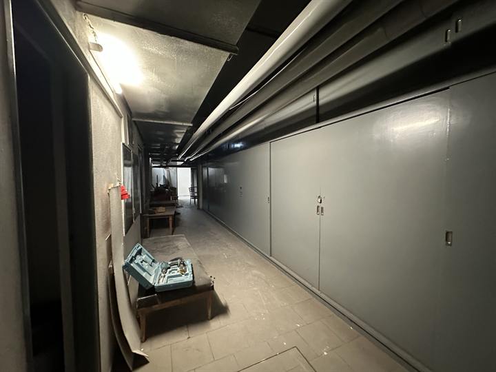 Long lower corridor lined with steel cabinets
