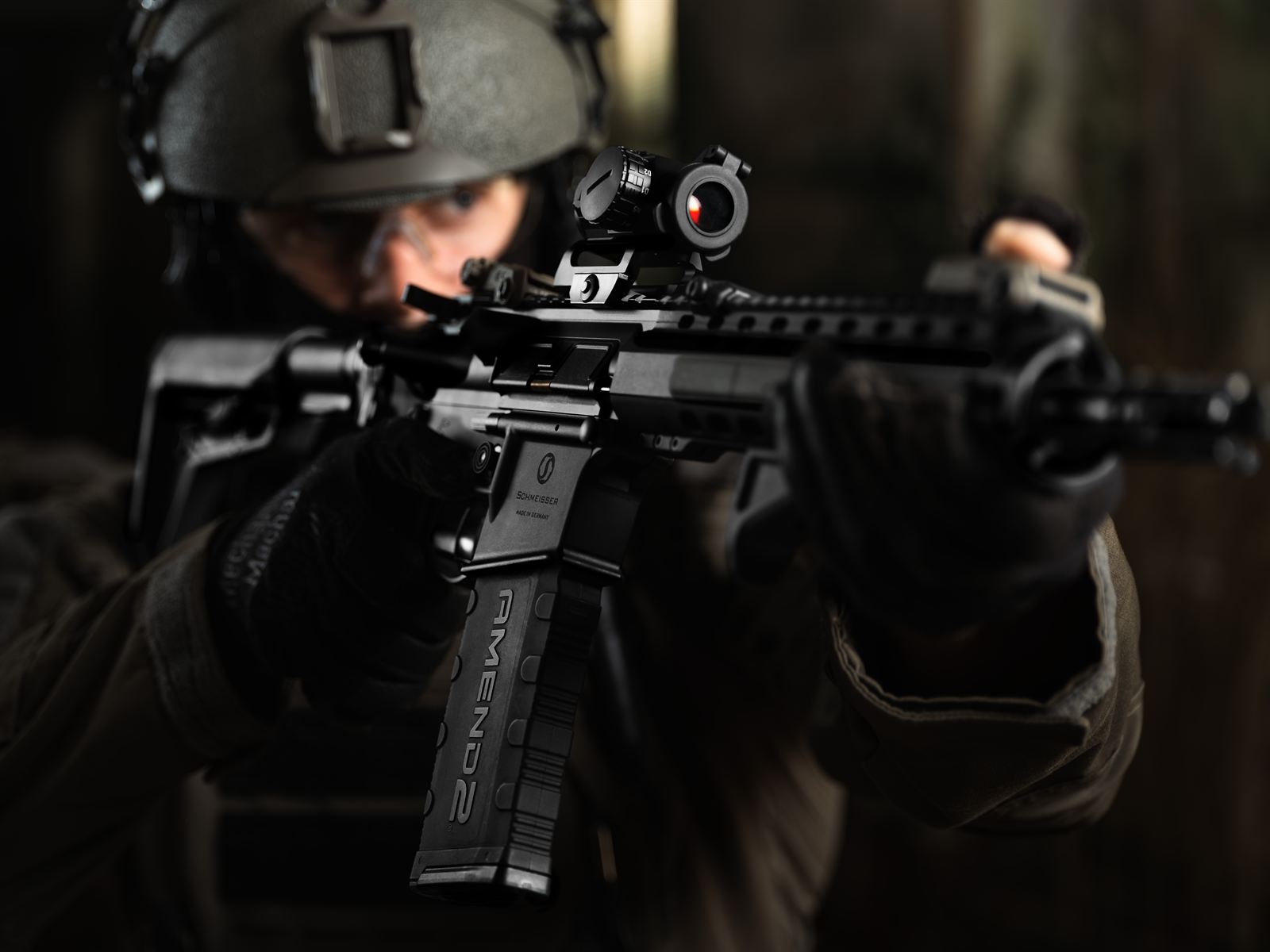 Operator aiming a rifle toward camera